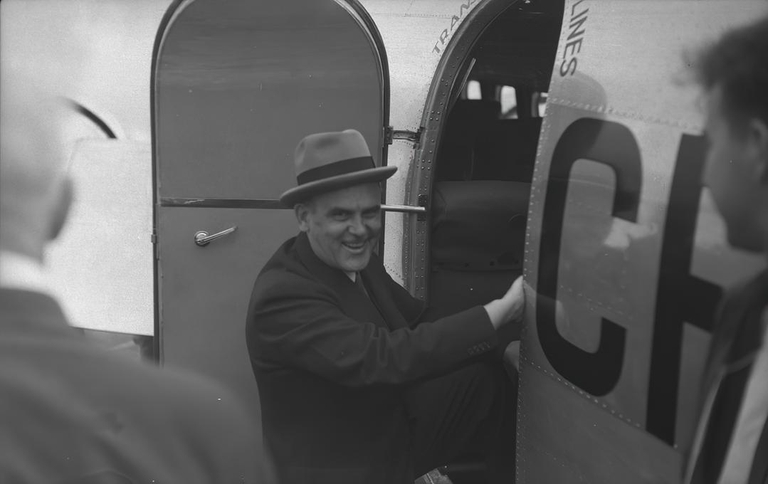 Minister of transport Hon C.W. Wowe stepping into a Lockheed 14 of trans Canada Air Lines for a survey over the airway to Vancouver 23 July 1938.